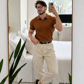 Homem com polo marrom masculina, cinto preto e calça bege, corpo inteiro no espelho
